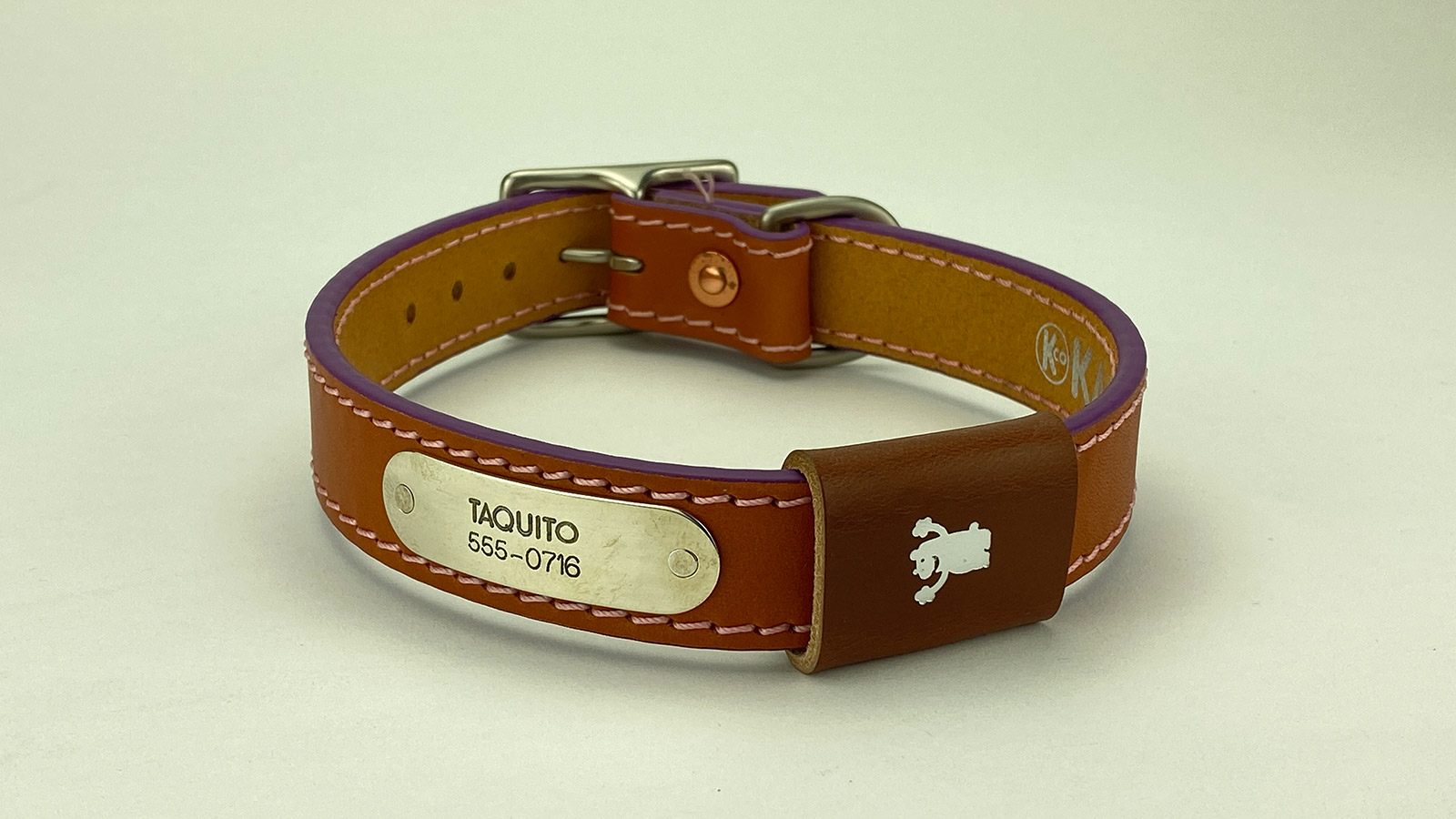 #10. Chesnut leather, pink stitch, violet edge, tan badge. Shown with satin nickel hardware.