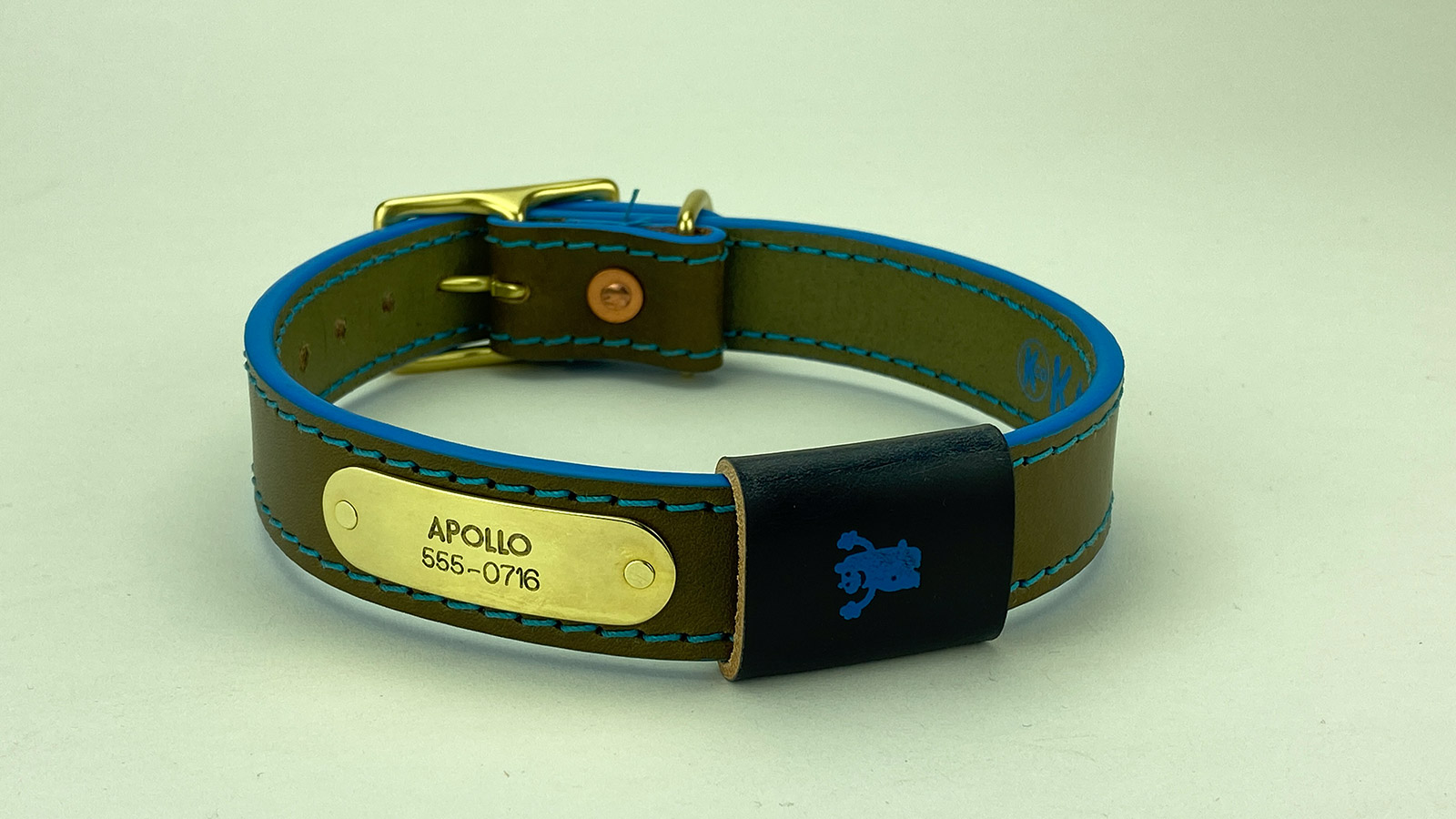 #6. Olive leather, teal stitch, super blue edge, midnight blue badge. Shown with natural brass hardware.
