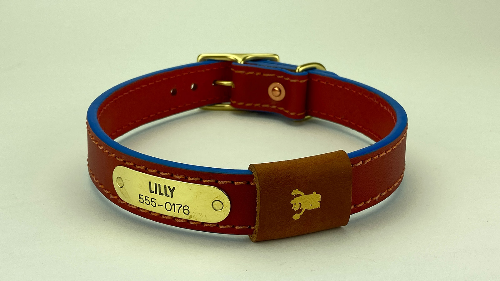 #9. Red leather, tangerine stitch, super blue edge and tan badge. Shown with natural brass hardware.
