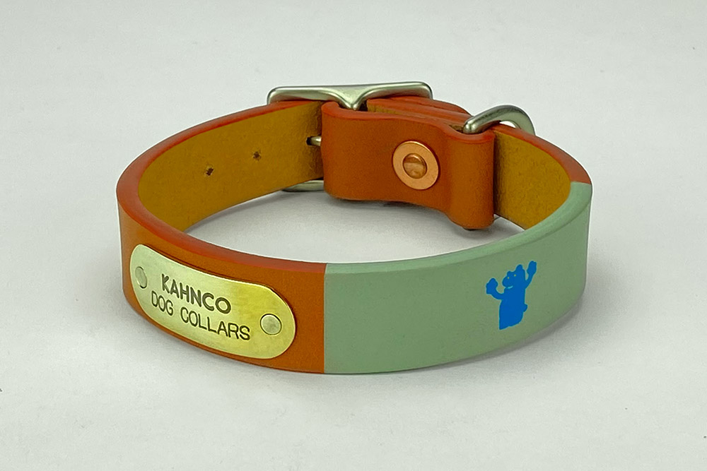 #23. Tan leather, grey band, blue bear, coral edge and satin nickel hardware. Shown in 3/4” width.
